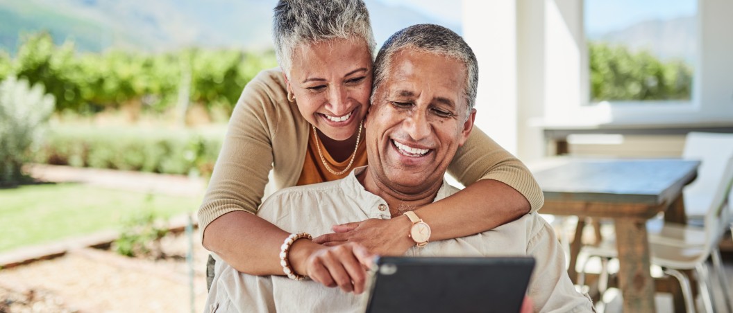 roth ira near manlius ny happy retired couple looking at tablet