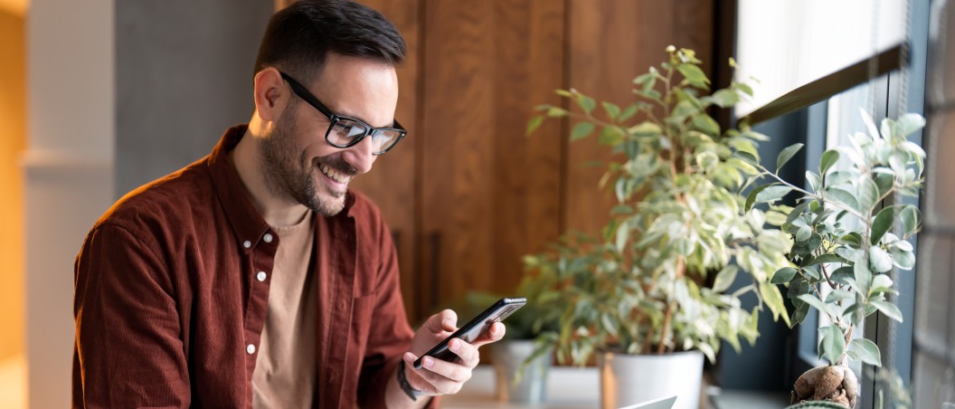 cd rates near manlius ny man checking his certificate of deposit on his phone