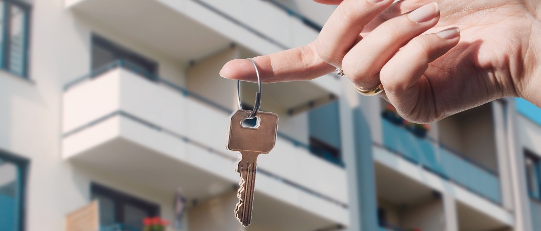 person holding keys to rent vs buy services at geddes federal savings and loan near syracuse ny