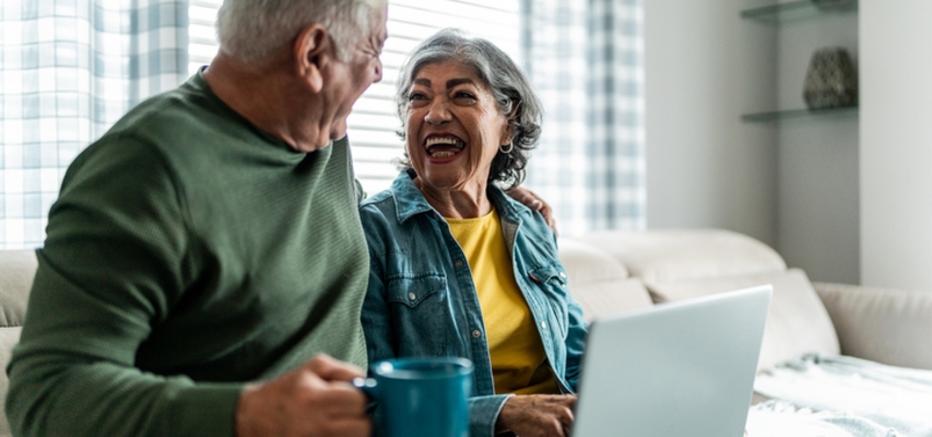 mortgage refinance near syracuse ny happy senior couple on laptop