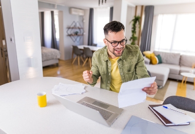 heloc rates near syracuse ny man holding paper next to laptop
